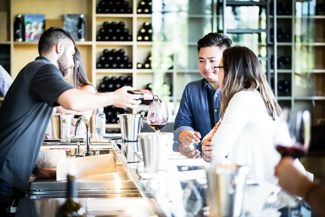 A couple enjoying a wine tasting at the tasting bar 