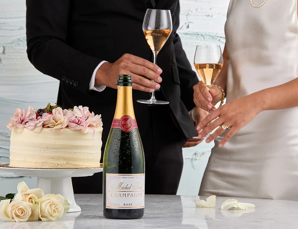 ride and groom toasting Champagne beside their wedding cake during a wedding reception