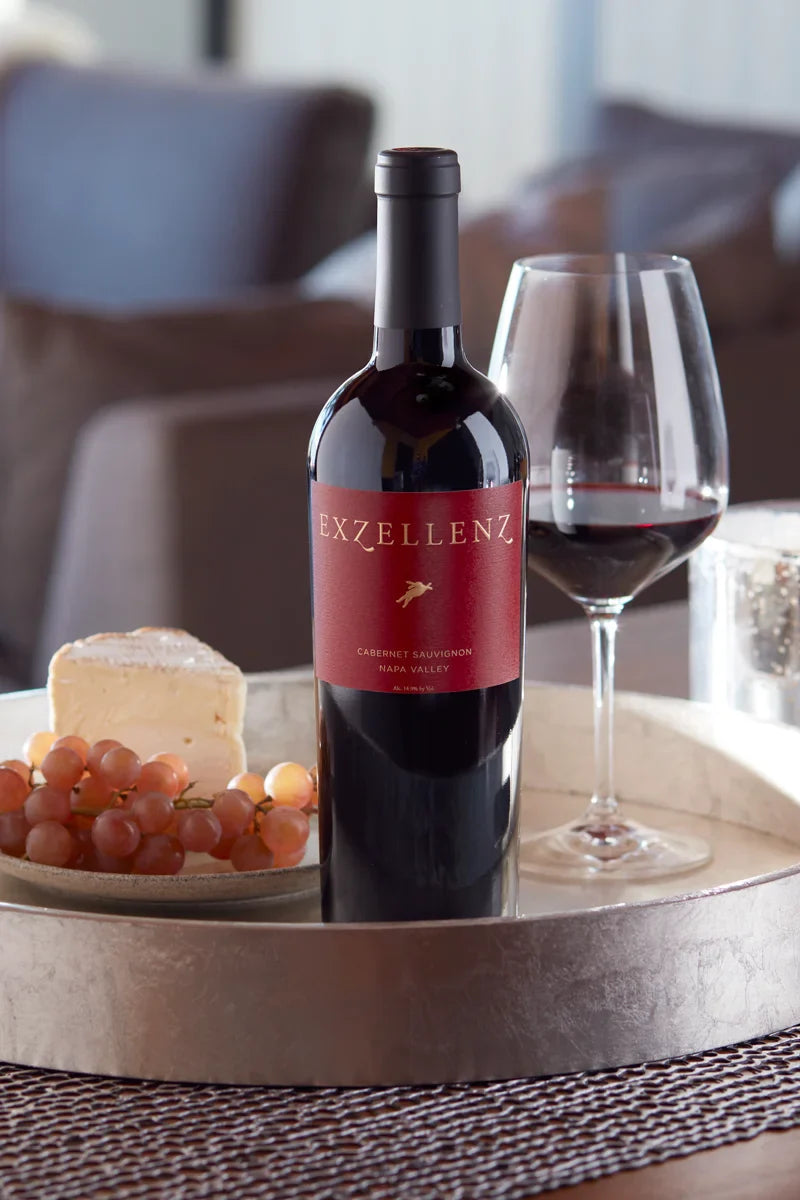 2017 HALL Exzellenz Cabernet Sauvignon on tray with cheese, fruit, and glass of red wine