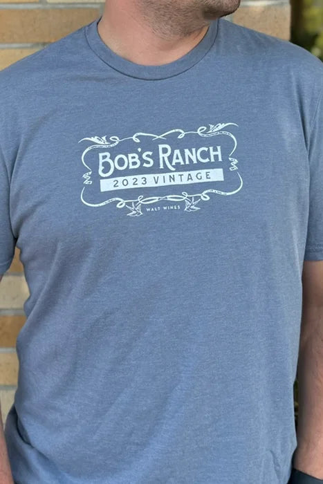 Photo of a man wearing a light blue t-shirt featuring a WALT Wines Bob's Ranch 2023 Vintage logo
