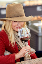 Woman smelling glass of red wine featuring 2019 HALL Exzellenz Cabernet Sauvignon