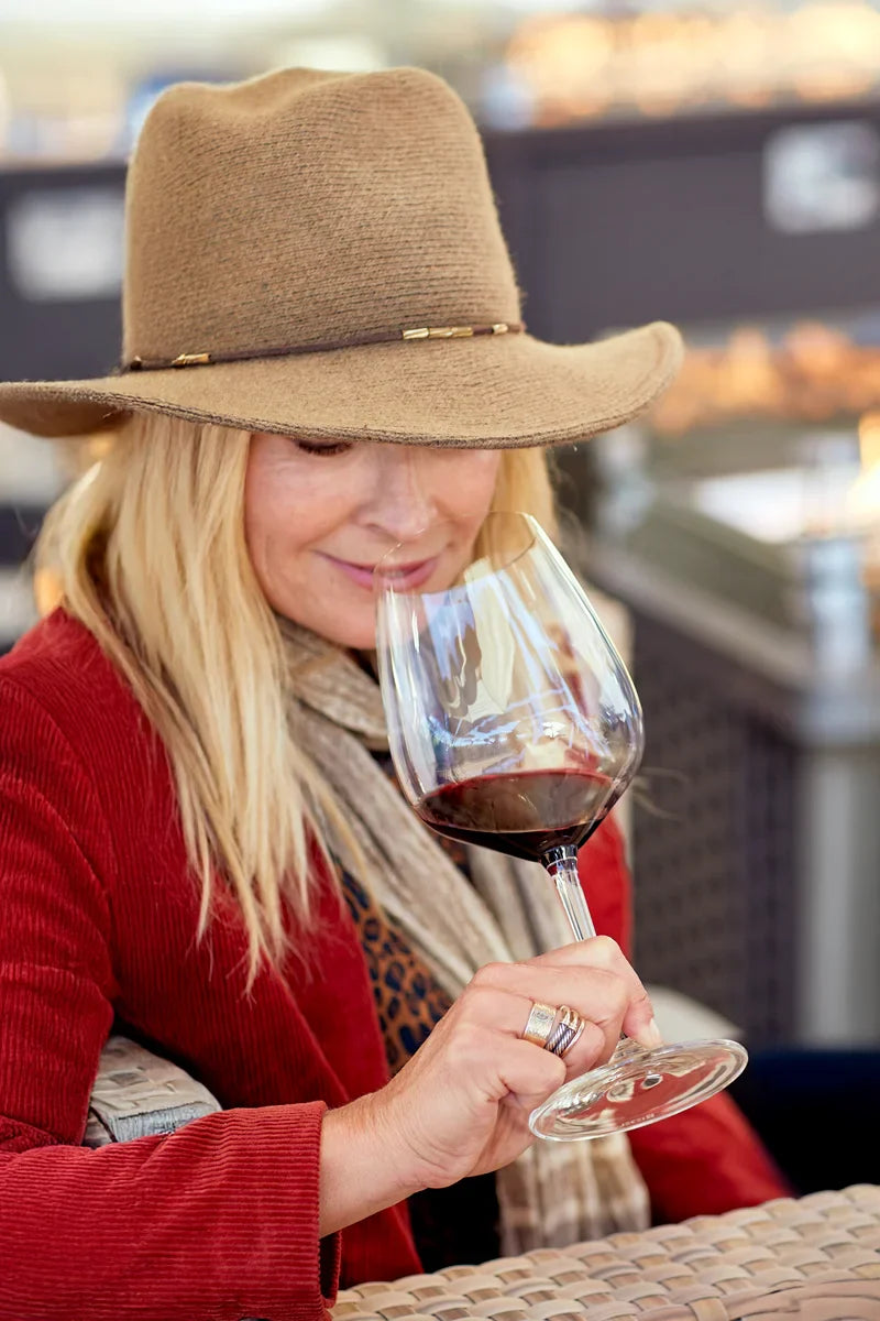 Woman smelling glass of red wine featuring 2017 HALL Exzellenz Cabernet Sauvignon