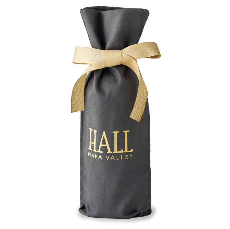 Image of a grey cloth gift bag with HALL Napa Valley in Gold letters and a gold bow