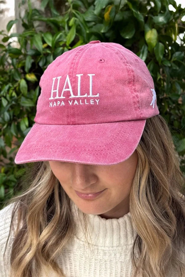 Image of a woman wearing a HALL nautical red baseball cap.