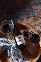 Two glasses of red wine and a bottle of Walt Sierra Mar